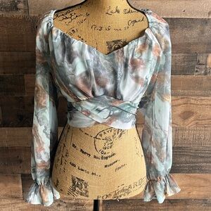 Adorable crop style top that ties with a bow in the back
